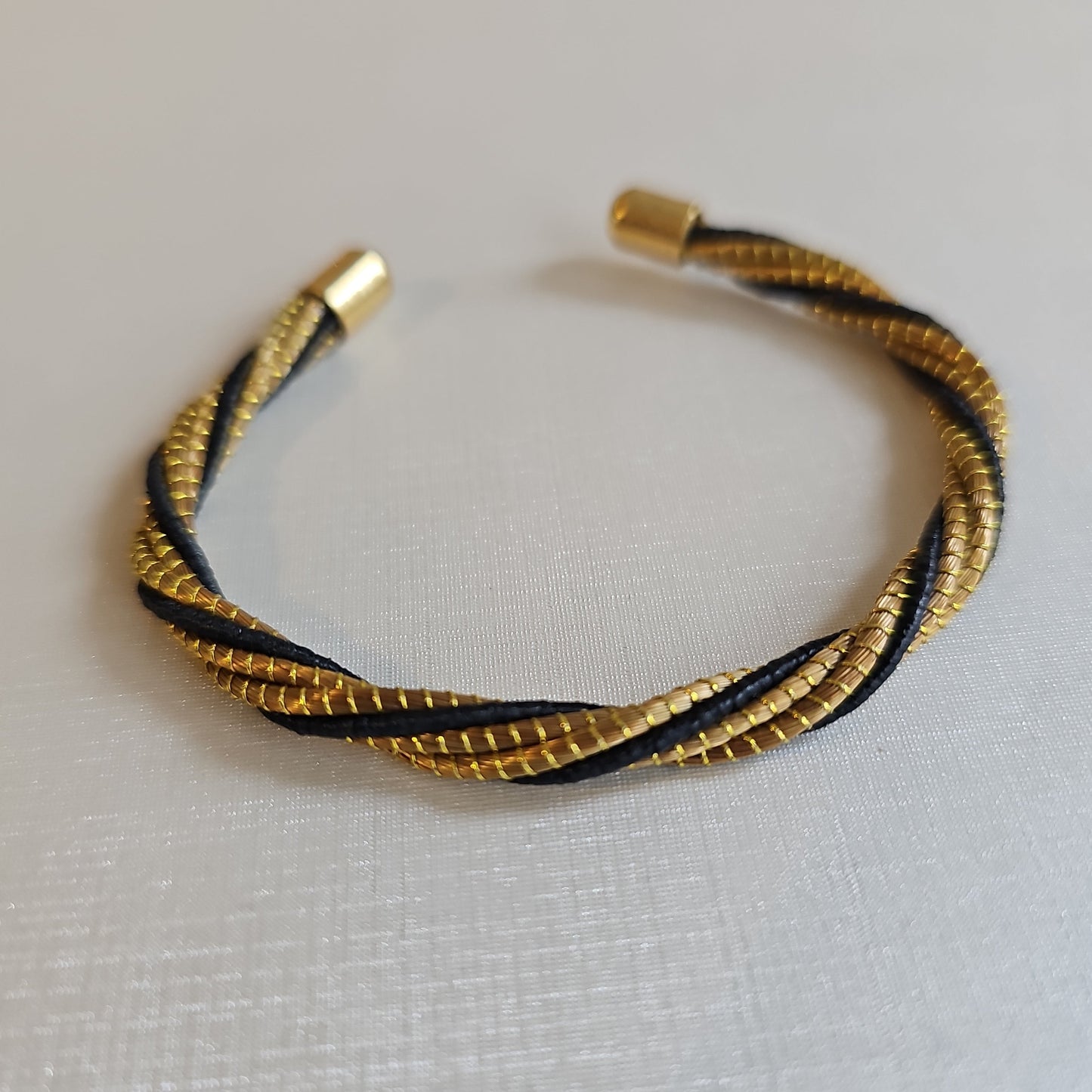 Golden Grass Open Bangle Bracelet with a black finish.