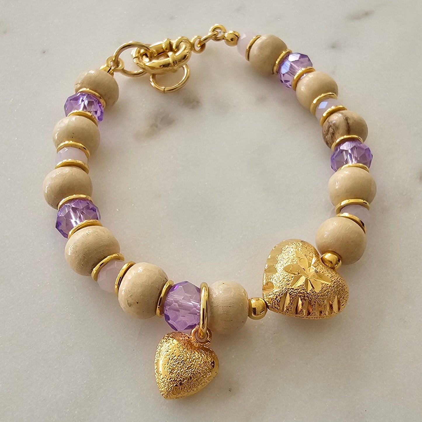 18K Gold Plated Bracelet with purple crystals, wood balls, and heart pendants.