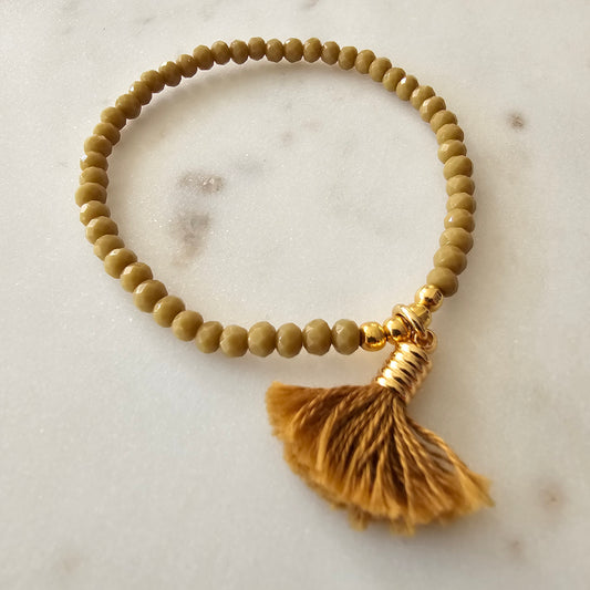 18K Gold Plated Bracelet with green crystals and pompom details.