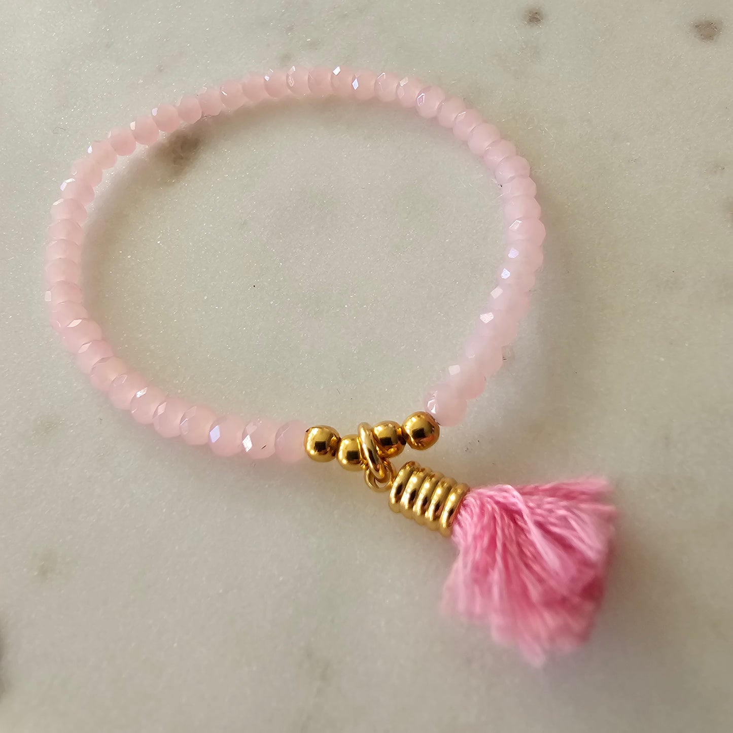 18K Gold Plated Bracelet with light pink crystals and pompom charms.