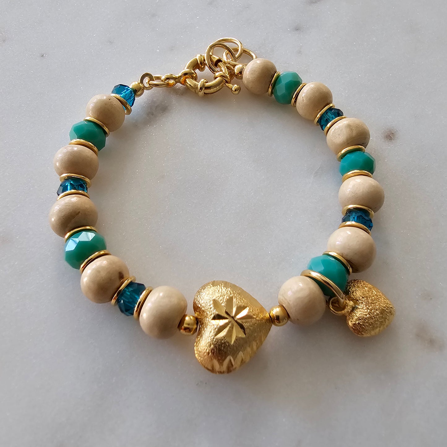 18K Gold Plated Bracelet with green crystals, wood balls, and heart pendants.