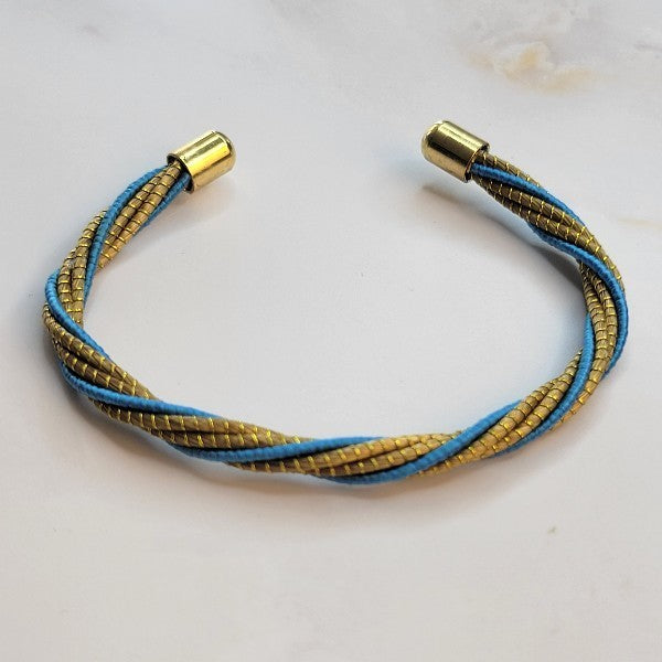 Golden Grass Open Bangle Bracelet with blue details.