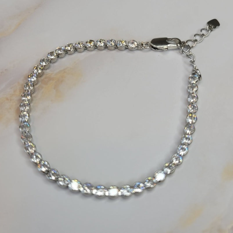 White Rhodium Plated Bracelet with bezel-set zirconia stones.