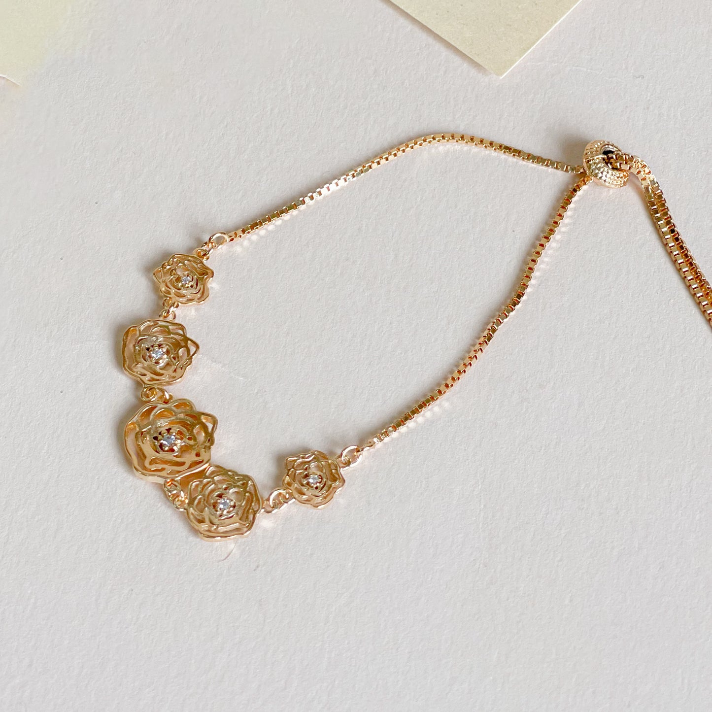 18K Gold Plated Bracelet with adjustable flower zirconia accents.