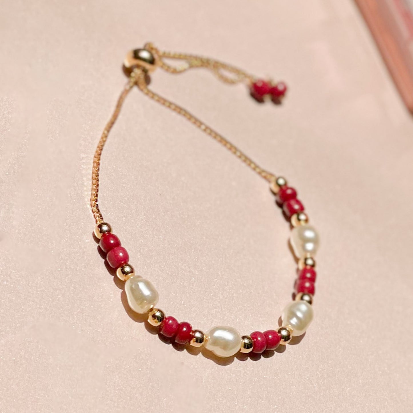 18K Gold Plated Bracelet with adjustable pink balls and pearls.
