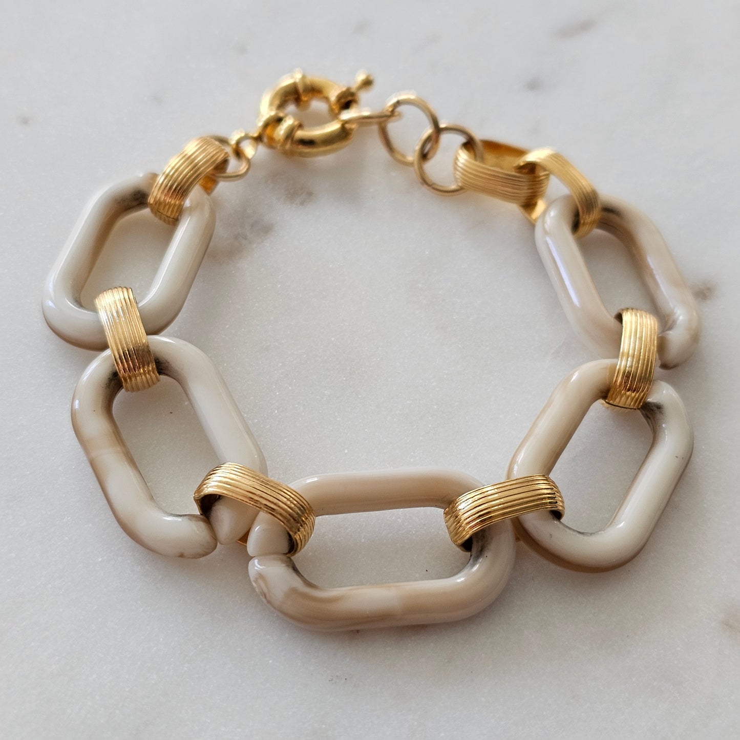 18K Gold Plated Bracelet with cream link resin accents.